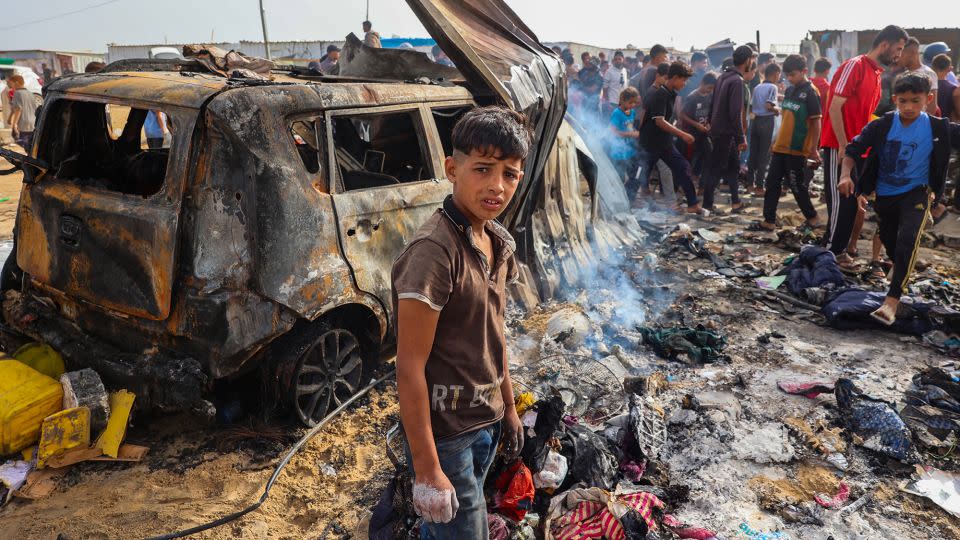 Palestinians gather at the site of an Israeli strike on a camp housing internally displaced people in Rafah, Gaza on Monday. - Eyad Baba/AFP/Getty Images