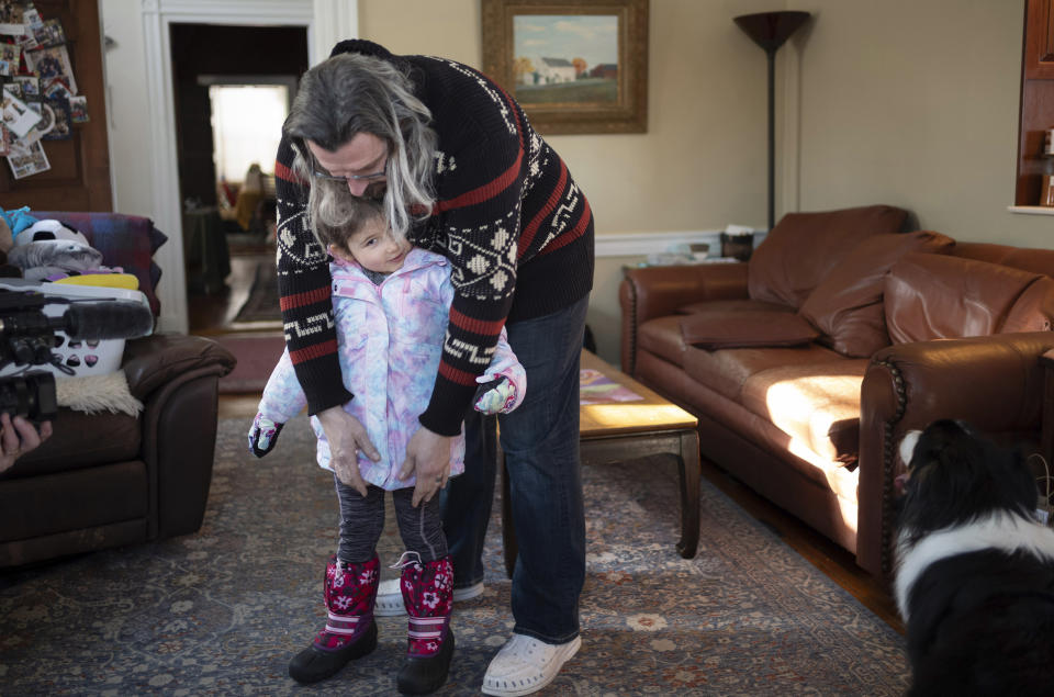 Curt Balsh gets his daughter ready for school in Hellertown, Penn. on Wednesday, Jan. 17, 2024. President Joe Biden is warning that Donald Trump will be a grave threat to American democracy if he wins re-election, but interviews with Pennsylvania voters again suggest it's not resonating. Balch, 44, worked in the health care industry and is now a stay-at-home dad. He said the messaging by both sides is “pretty toxic” when they warn that the other is “a threat or a danger to the fundamentals of the country moving forward." (AP Photo/Laurence Kesterson)