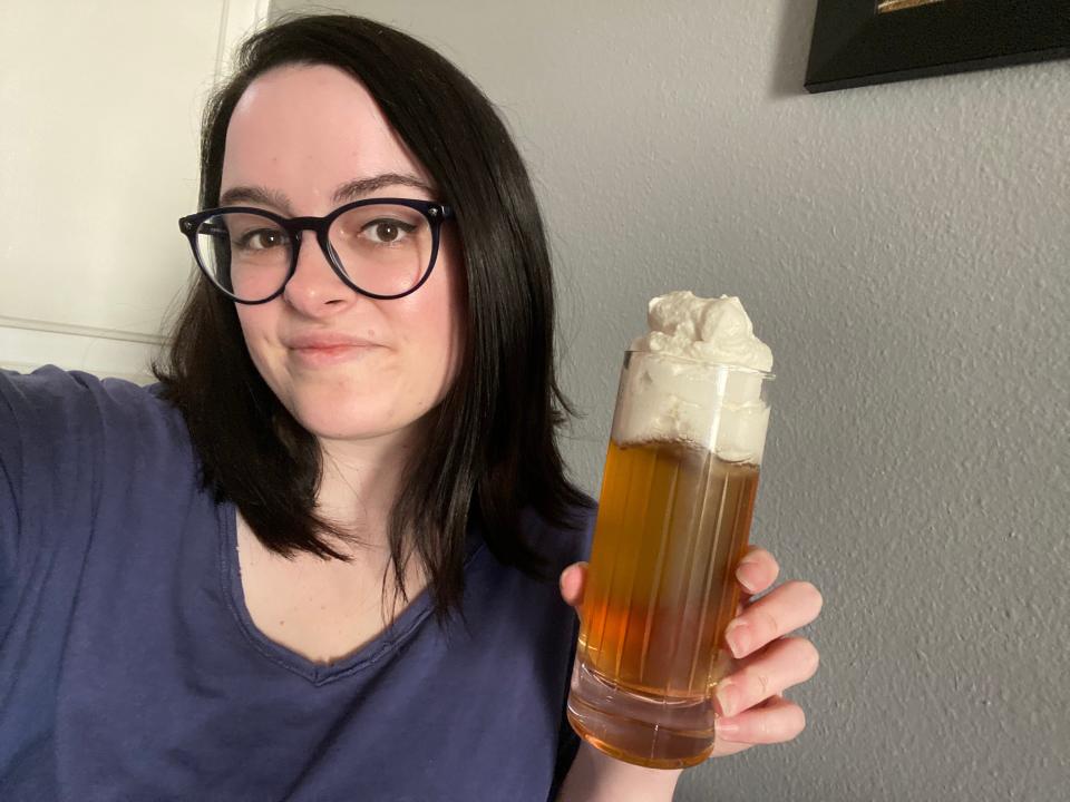 paige holding glass of butterbeer with sweet cream on top