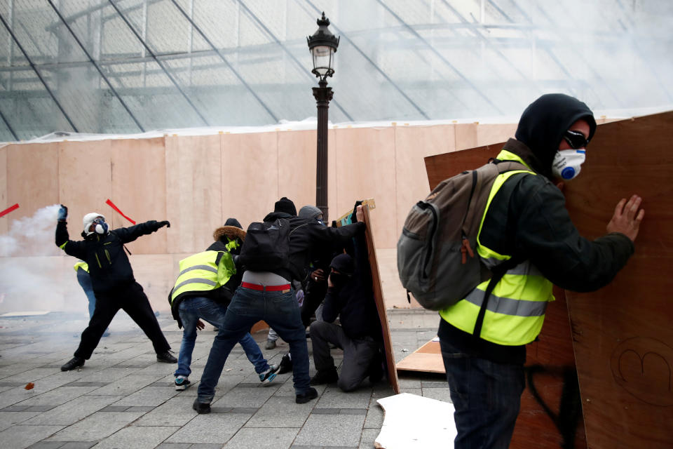 Protesters wearing yellow vests face off with police forces during clashes on the Champs-Elysees Avenue during a national day of protest by the “yellow vests” movement in Paris, France, Dec. 8, 2018. (Photo: Christian Hartmann/Reuters)