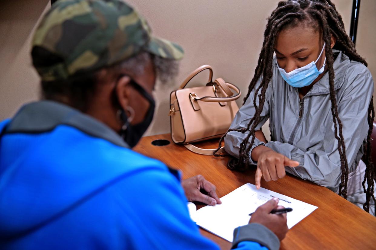 Diane Robinson, left, VITA/Senior Services program manager at the Social Development Commission, goes over tax returns with Shaynah Neeley, 17.