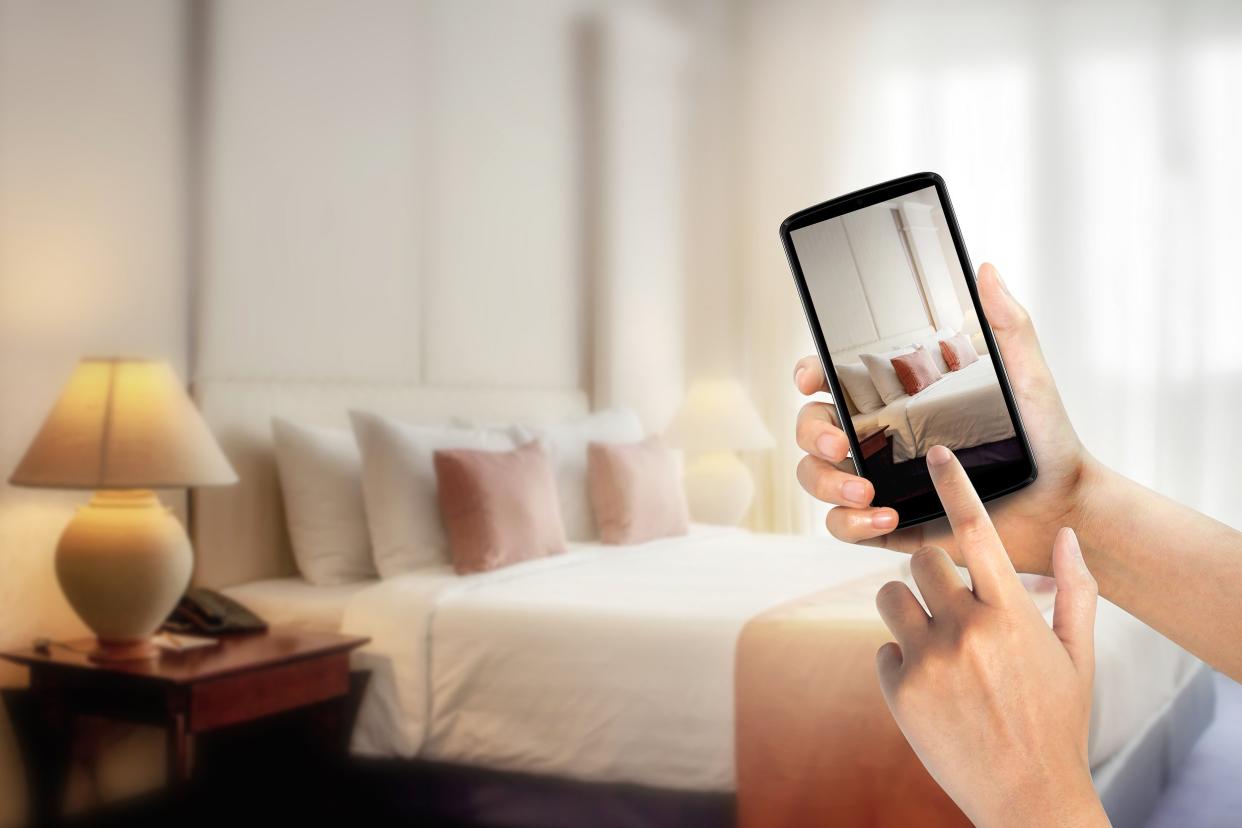 woman hands using mobile phone take photo at hotel room