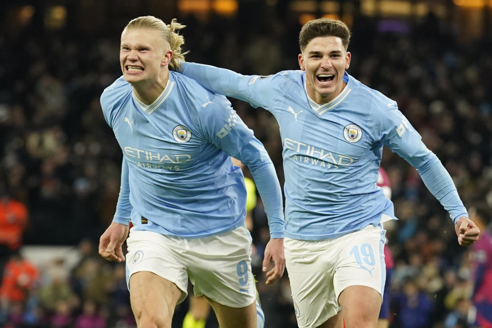 Manchester City's Julian Alvarez, right, celebrates with Manchester City's Erling Haaland after scoring his side's third goal during the group G Champions League soccer match between Manchester City and RB Leipzig at the Etihad stadium in Manchester, England, Tuesday, Nov. 28, 2023. (AP Photo/Dave Thompson)
