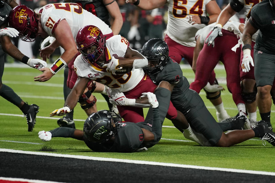 Iowa State running back Breece Hall (28) is tackled by UNLV linebacker Jacoby Windmon, right, near the goal line during the first half of an NCAA college football game Saturday, Sept. 18, 2021, in Las Vegas. (AP Photo/John Locher)