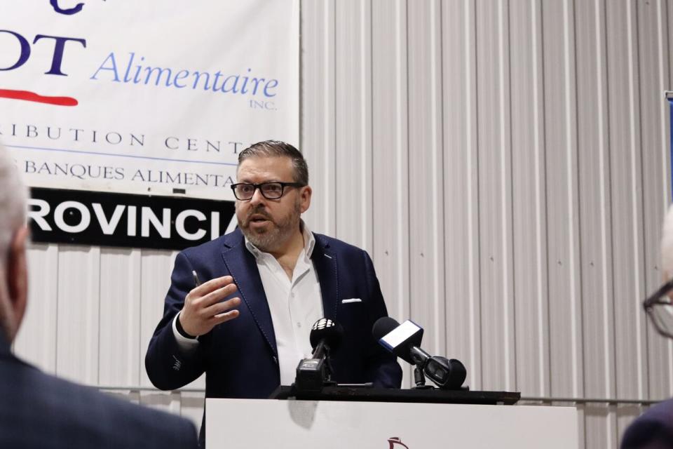 Stéphane Sirois, executive director of Food Depot Alimentaire, speaks at a news conference in the organization's warehouse in Moncton on Jan. 29, 2024.