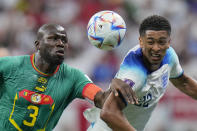 England's Jude Bellingham, right, challenges with Senegal's Kalidou Koulibaly during the World Cup round of 16 soccer match between England and Senegal, at the Al Bayt Stadium in Al Khor, Qatar, Sunday, Dec. 4, 2022. (AP Photo/Hassan Ammar)