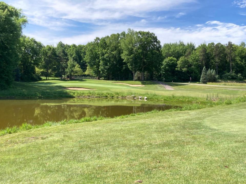 A fairway view to the par-4 seventh green, the toughest on the course, over a pond filled with rain water at Huntmore Golf Club in Brighton Township.