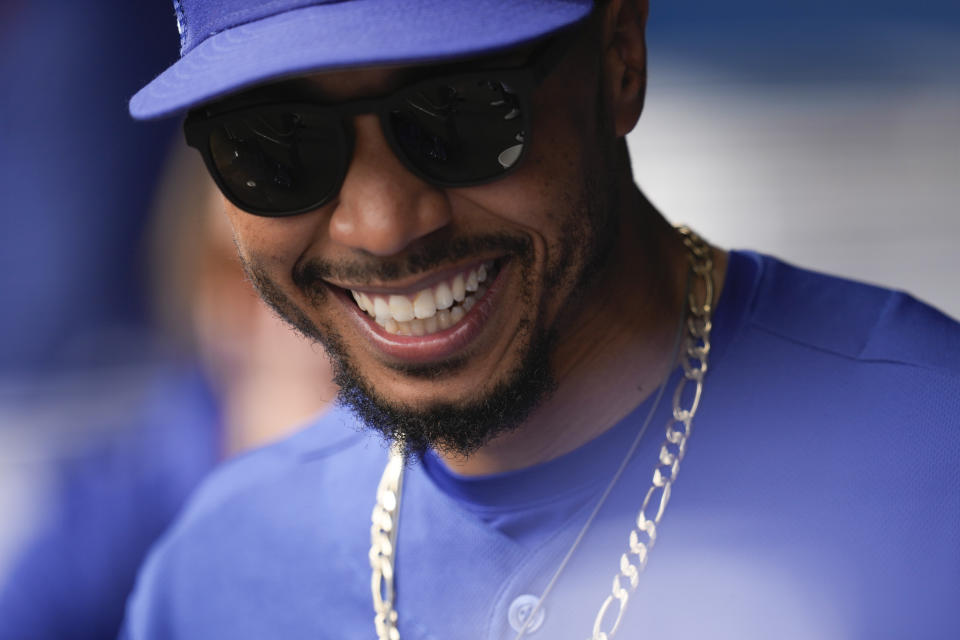 Los Angeles Dodgers right fielder Mookie Betts (50) smiles in the dugout before a spring training baseball game against the San Diego Padres in Glendale, Calif., Monday, March 6, 2023. (AP Photo/Ashley Landis)