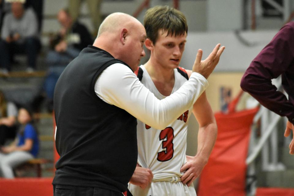 Orleans assistant Mark Wheeler coaches up Carter Allen during a timeout against Crawford County.