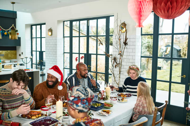 Multi generational family sitting down for Christmas dinner