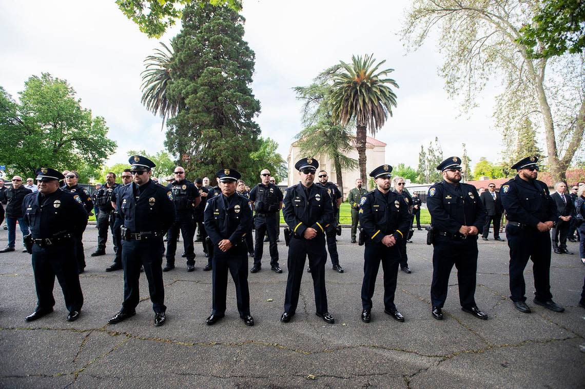 Merced police officers and fellow first responders look on during an annual ceremony to honor fallen Merced Police officer Stephan Gray at the Merced Police Station in Merced, Calif., on Monday, April 15, 2024. Gray was shot and killed in the line of duty on April 15, 2004.
