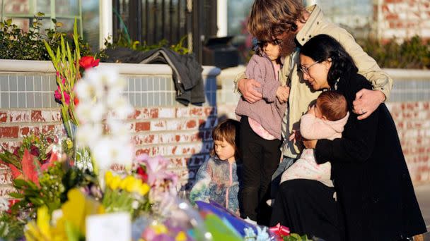 PHOTO: After a mass shooting, a family gathers at a memorial outside the Star Ballroom Dance Studio, Jan. 24, 2023, in Monterey Park, Calif. (Ashley Landis/AP)