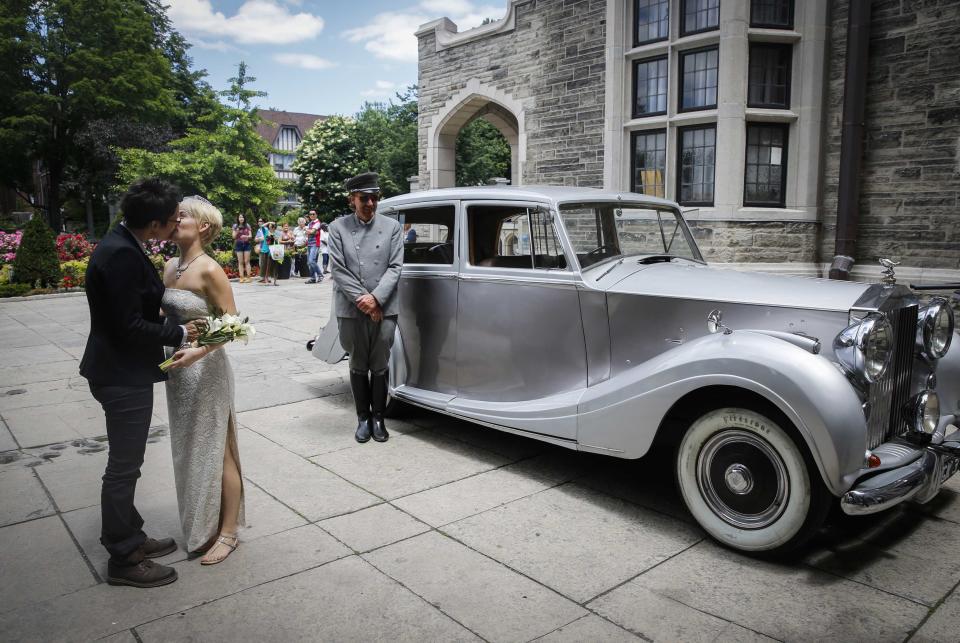 Neales kisses her partner Tweddle as they arrive for "The Celebration of Love" at Casa Loma in Toronto