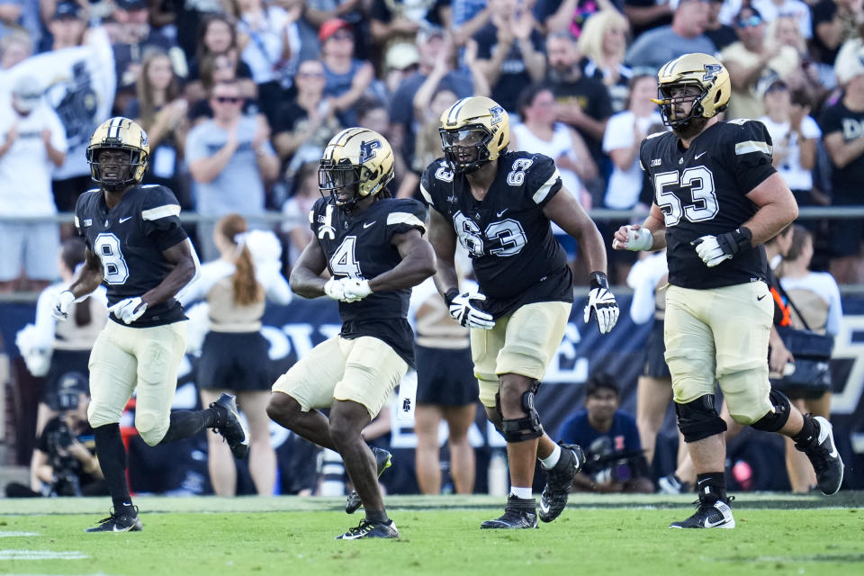 Purdue wide receiver Deion Burks (4) celebrates a touchdown against Illinois during the second half of an NCAA college football game in West Lafayette, Ind., Saturday, Sept. 30, 2023. (AP Photo/Michael Conroy)