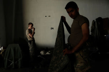 Soldiers from the First Armored Division's Combat Aviation Brigade prepare in their sleeping quarters during recovery efforts following Hurricane Maria at their base in Roosevelt Roads Naval Station, Puerto Rico, October 8, 2017. REUTERS/Lucas Jackson