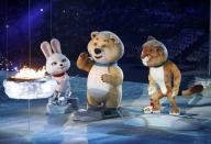 Olympic Games mascots extinguish the Olympic flame in a small cauldron in the stadium, during the closing ceremony for the 2014 Sochi Winter Olympics, February 23, 2014. REUTERS/Grigory Dukor (RUSSIA - Tags: OLYMPICS SPORT)