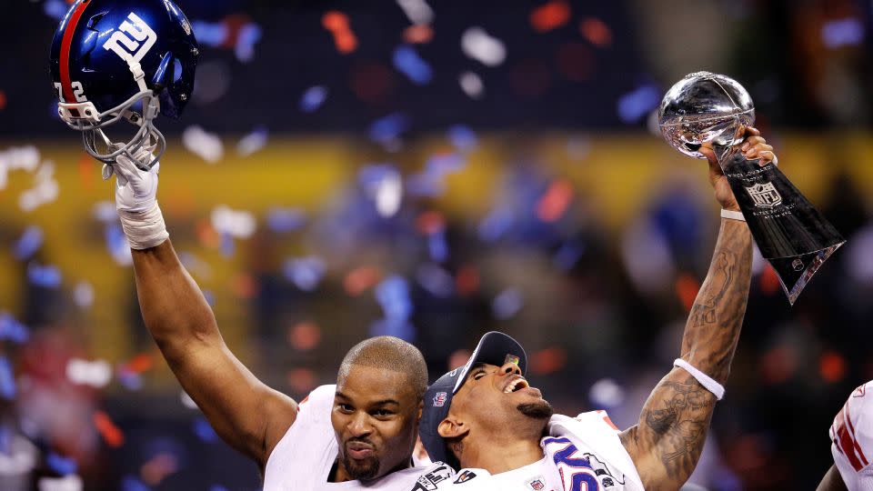 Umenyiora (left) celebrates his second Super Bowl victory with teammate Devin Thomas after the Giants defeated the New England Patriots in Super Bowl XLVI in 2012. - Rob Carr/Getty Images