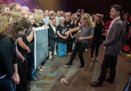 There's Styx! Styx's Tommy Shaw points out Pluto's smallest moon with New Horizons team members looking on.