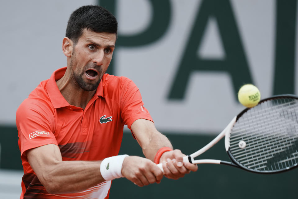 Serbia's Novak Djokovic backhands to Slovakia's Alex Molcan during their second round match of the French Open tennis tournament at the Roland Garros stadium Wednesday, May 25, 2022 in Paris. (AP Photo/Thibault Camus)