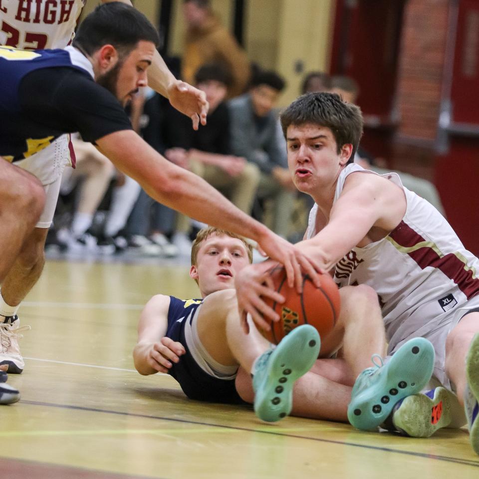 BC High's Dan Civello, of Weymouth, dives for a loose ball during a game against Xaverian on Tuesday, Jan. 23, 2024.