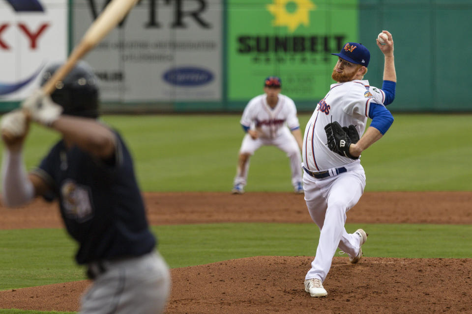 FILE - Midland RockHounds pitcher Brady Feigl throws during a Double-A baseball game against the San Antonio Missions on May 11, 2021, in Midland, Texas. Major League Baseball agreed to pay minor leaguers $185 million to settle a federal lawsuit alleging violations of minimum wage laws, a case that progressed through the courts for eight years without reaching a trial. (Eli Hartman/Odessa American via AP, File)