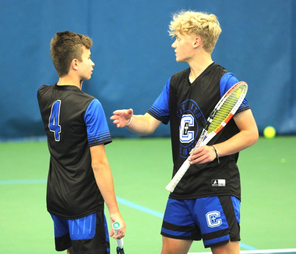 Covington Catholic doubles teammates Jacob Kramer, left, and William Tribble discuss strategy during their semifinal win in the KHSAA Ninth Region boys tennis singles and doubles semifinals May 14.