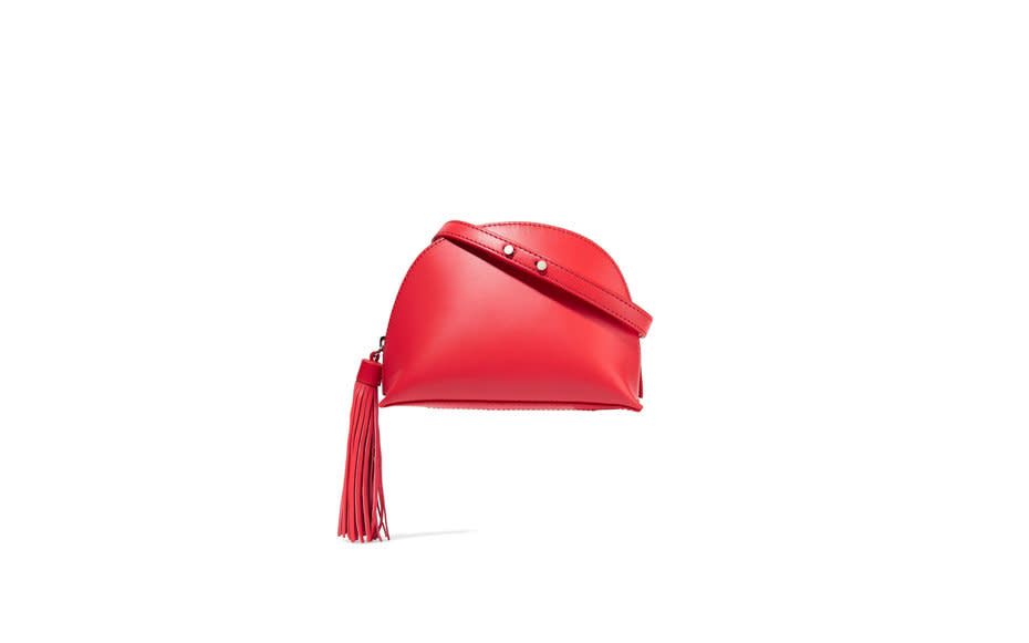 <p>Pair this papaya leather bag with a flame-red lip to up the sass factor on any outfit in <a rel="nofollow noopener" href="http://www.travelandleisure.com/style/travel-bags/best-designer-luggage-brands" target="_blank" data-ylk="slk:your suitcase;elm:context_link;itc:0;sec:content-canvas" class="link ">your suitcase</a>.</p><p>To buy: <a rel="nofollow noopener" href="http://click.linksynergy.com/fs-bin/click?id=93xLBvPhAeE&subid=0&offerid=254156.1&type=10&tmpid=6894&RD_PARM1=https%3A%2F%2Fwww.net-a-porter.com%2Fus%2Fen%2Fproduct%2F743906%2FLoeffler_Randall%2Ftasseled-leather-shoulder-bag&u1=TL_crossbodybags" target="_blank" data-ylk="slk:netaporter.com;elm:context_link;itc:0;sec:content-canvas" class="link ">netaporter.com</a>, $195.</p>