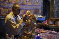 A man decorates traditional sugar candy at a market in the Egyptian capital on November 19, 2018, ahead of celebrations marking birthday of Prophet Mohammed