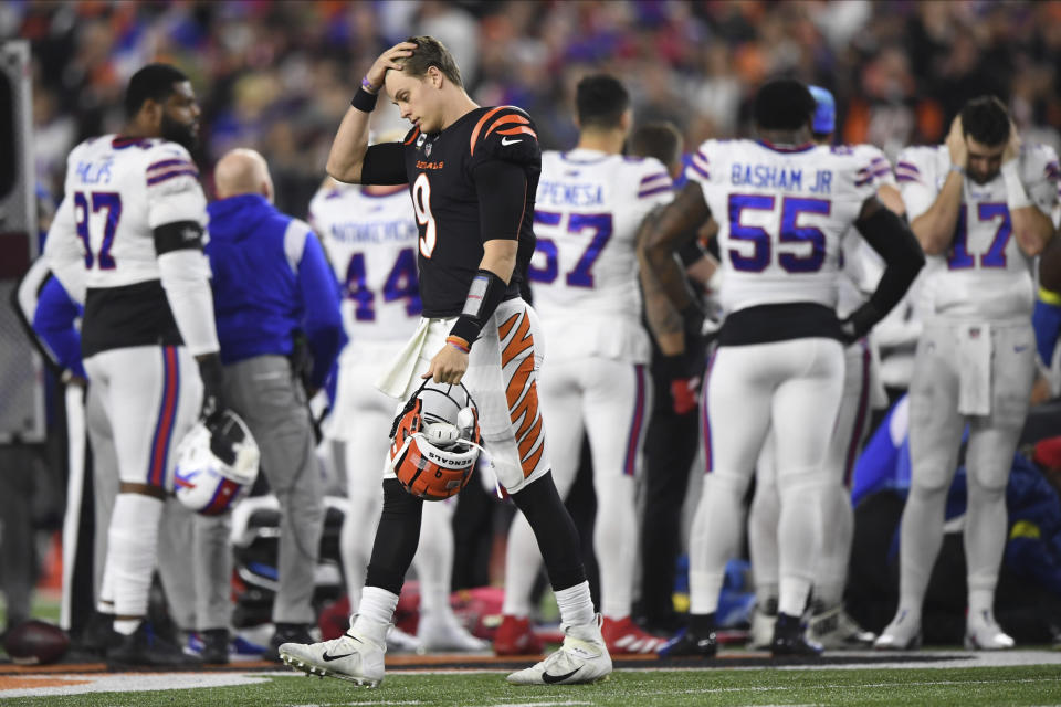 Cincinnati Bengals quarterback Joe Burrow (9) pauses as Buffalo Bills' Damar Hamlin is examined by medical staff during the first half of an NFL football game, Monday, Jan. 2, 2023, in Cincinnati. (AP Photo/Emilee Chinn)