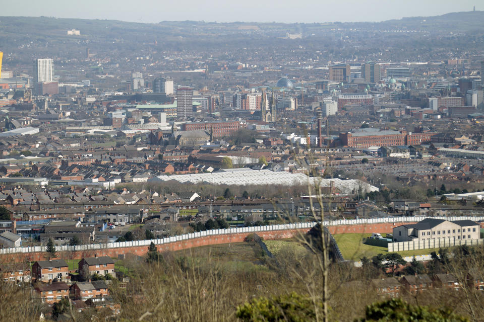 A general view of the peace wall that still divides loyalist and nationalist communities Belfast, Northern Ireland, Friday, March 24, 2017.Almost 20 years on from the Good Friday peace accord, which brought about the end of Northern Ireland's sectarian conflict, the city of Belfast has changed dramatically. Reminders of the past are everywhere _ murals and memorials to those killed in the conflict, along with peace walls that separate predominantly Protestant neighborhoods from mostly Catholic ones _ but there are also new shopping malls and cafes, new tech industries, and lots of tourists. (AP Photo/Peter Morrison)