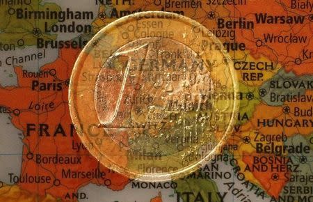 A picture illustration taken with the multiple exposure function of the camera shows a one Euro coin and a map of Europe, January 9, 2013. REUTERS/Kai Pfaffenbach