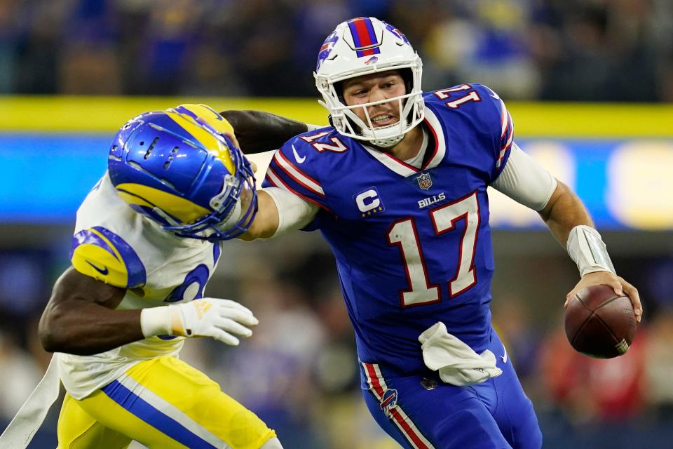 Buffalo Bills quarterback Josh Allen (17) stiff-arms Los Angeles Rams safety Nick Scott during the second half of an NFL football game Thursday, Sept. 8, 2022, in Inglewood, Calif. (AP Photo/Ashley Landis)