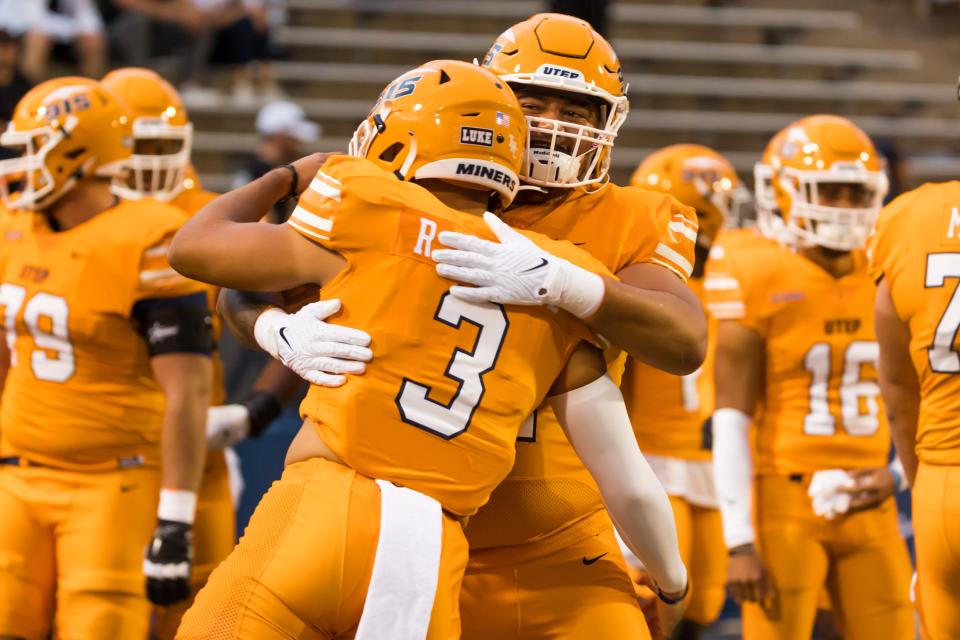 Two UTEP players celebrate a play during last Saturday's game against North Texas in El Paso.