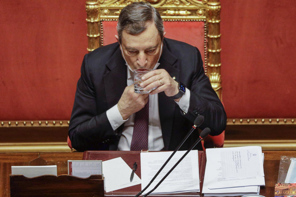 Italian Premier Minister Mario Draghi sips water at the end of his address at the Senate in Rome, Tuesday, April 27, 2021. Italian Premier Mario Draghi is presenting a 222.1 billion euro ($268.6 billion) coronavirus recovery plan to the Seante. The plan is aiming to not only bounce back from the pandemic but enact "epochal" reforms to address structural problems that long predated COVID-19.(AP Photo/Gregorio Borgia, Pool)