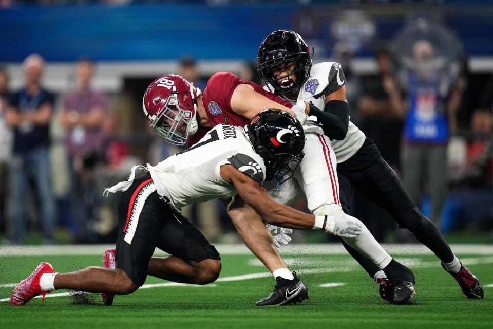Cincinnati's Tre Tucker (7) and Tyler Scott (21) tackle Alabama's Slade Bolden on a punt in the second quarter during the College Football Playoff semifinal game at the 86th Cotton Bowl, Friday, Dec. 31, 2021.