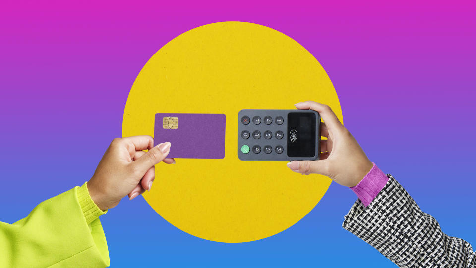 hands holding a credit card and calculator on a neon background