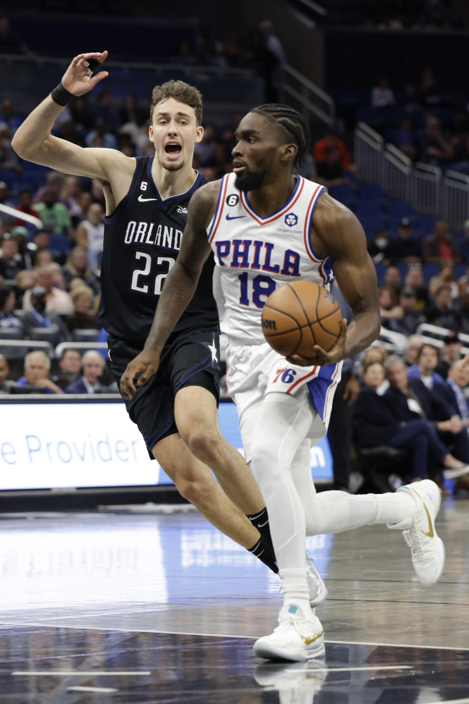 Philadelphia 76ers guard Shake Milton (18) drives against Orlando Magic forward Franz Wagner (22) during the first half of an NBA basketball game, Friday, Nov. 25, 2022, in Orlando, Fla. (AP Photo/Kevin Kolczynski)