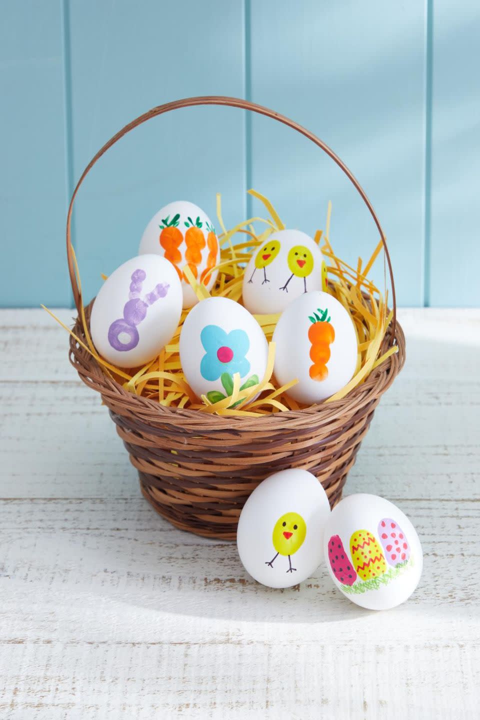 eggs decorated with kids fingerprints in a woven basket