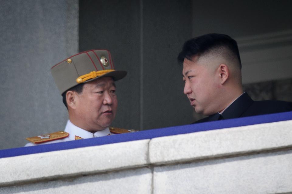 A photo taken on April 15, 2012 shows a man believed to be Choe Ryong-Hae (L) talking with North Korean leader Kim Jong-Un at a military parade in Pyongyang. Source: AFP