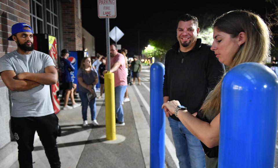 Amanda Sabolesky of Lakewood Ranch, checks her watch while waiting in line with her husband, John, at the Walmart at North Lockwood Ridge Road and University Parkway on Friday morning, Nov. 25, 2022 in Sarasota. The Saboleskys and Jose Barbarosa, left, of Sarasota were at the front of line and ready for the store to open at 6 a.m.