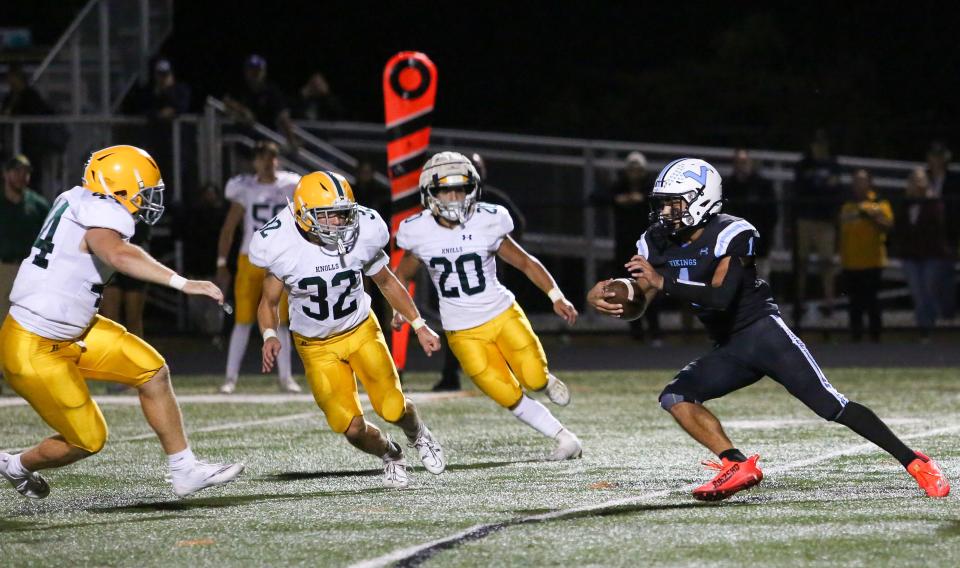 Parsippany Hills' Julio Tatis runs the ball as Morris Knolls defends during the first half of a football game at Parsippany Hills High School September 09, 2022. Alexandra Pais | Daily Record