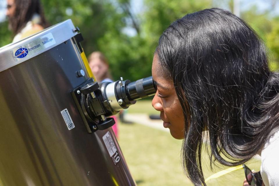 Sylvia Cartis views the solar eclipse through one of several telescopes setup outside Columbus State University’s Coca-Cola Space Science Center in Columbus, GA. 04/08/2024