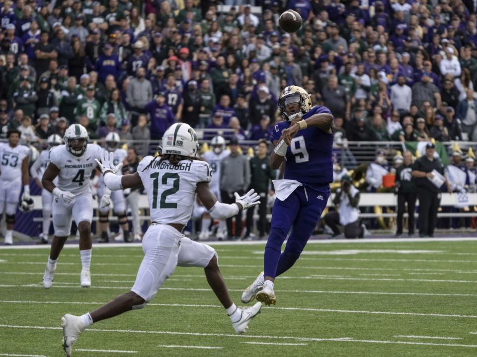 Washington quarterback Michael Penix Jr. throws a touchdown pass against Michigan State