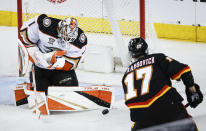 Anaheim Ducks goalie Lukas Dostal (1) kicks away a shot from Calgary Flames forward Yegor Sharangovich (17) during the second period of an NHL hockey game Tuesday, April 2, 2024, in Calgary, Alberta. (Jeff McIntosh/The Canadian Press via AP)