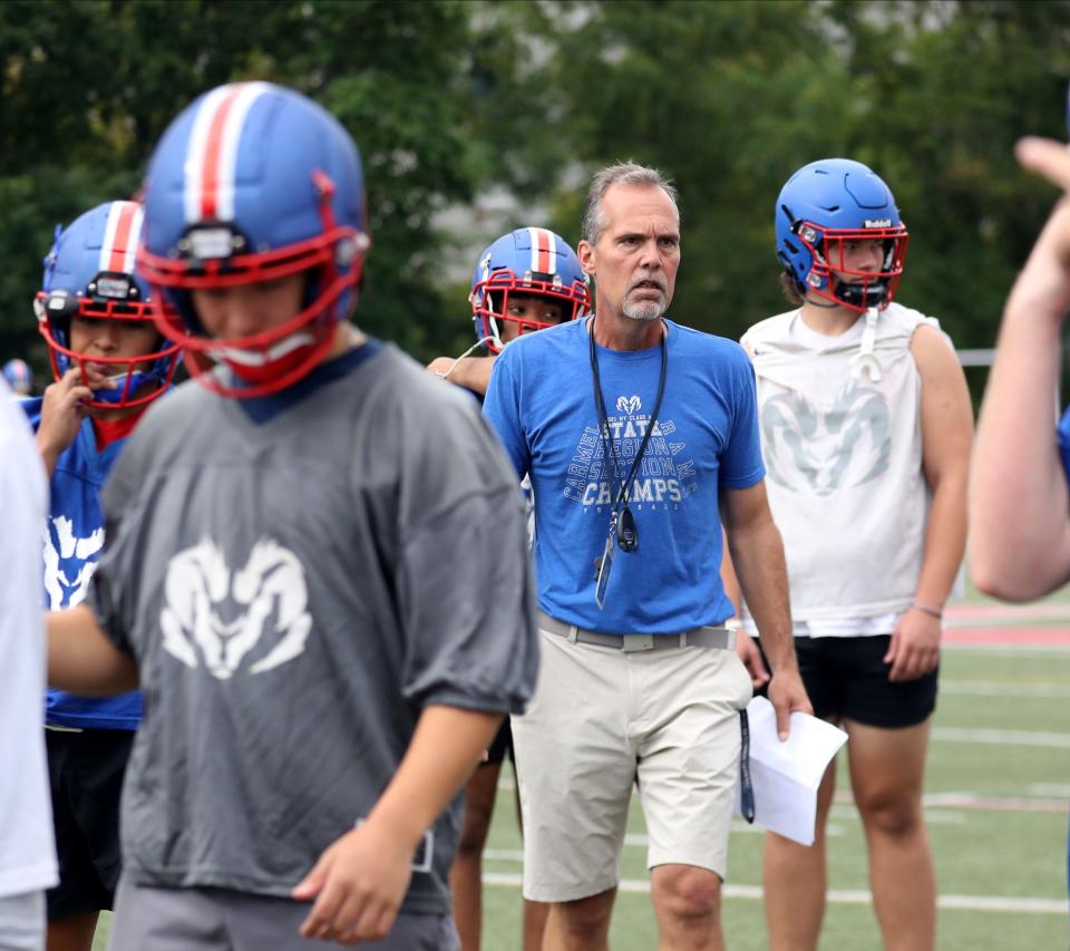 Todd Cayea, Carmel High School football coach, works with his team on the first day of practice Aug. 21, 2022.