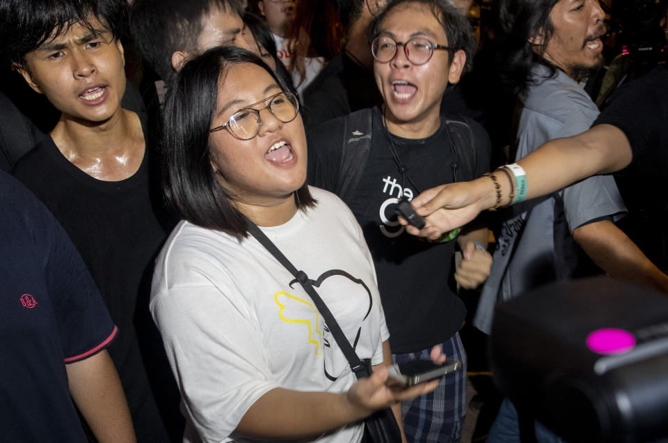 Pro-democracy activist and student leaders celebrate following a protest rally at Democracy Monument in Bangkok, Thailand, Sunday, Aug. 16, 2020. Protesters have stepped up pressure on the government demanding to dissolve the parliament, hold new elections, amend the constitution and end intimidation of the government's opponents. (AP Photo/Gemunu Amarasinghe)