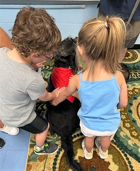 A therapy dog and his handler visit the Extended School Year (ESY) Program at Wilson Elementary School on Friday, July 22.