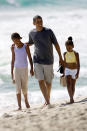 Democratic presidential candidate Sen. Barack Obama, D-Ill. walks down the beach with his daughters Malia, 10, left, and Sasha, 7, during his vacation to Hawaii, Tuesday, Aug. 12, 2008 in Kailua, Hi. (AP Photo/Marco Garcia)