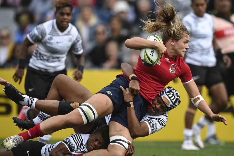 Zoe Aldcroft of England is tackled by a defender during the Women's Rugby World Cup pool match between England and Fiji, at Eden Park, Auckland, New Zealand, Saturday, Oct.8. 2022. (Andrew Cornaga/Photosport via AP)