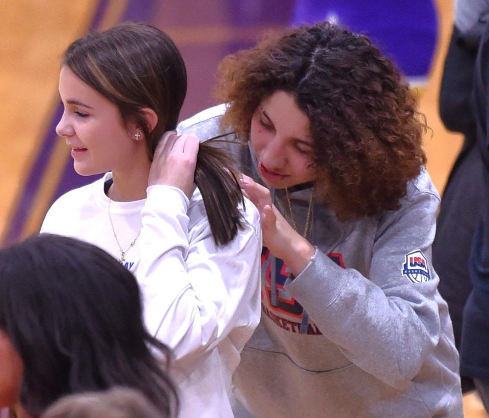 Lubbock Monterey junior Aaliyah Chavez, right, signs a fan's shirt after the Lady Plainsmen beat Abilene Wylie 58-43 in a District 4-5A girls basketball game Tuesday, Jan. 2, 2024, at Bulldog Gym in Abilene.